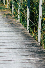 Closeup of a rustic wooden bridge spanning a pond in the french countryside in the fall