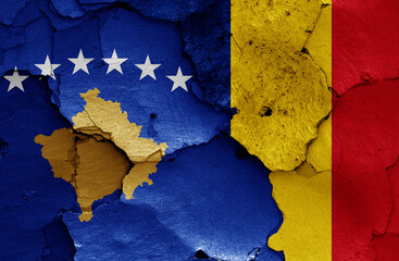 flags of Kosovo and Romania painted on cracked wall