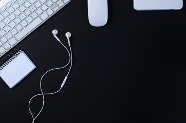 Top view of office work space, black desk table with keyboard, mouse, notebook and external hard drive. With a copy space, flat lay