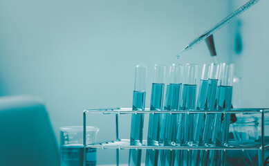 Pipette dropping a sample into a test tube and science experiments ,Laboratory glassware containing chemical liquid,