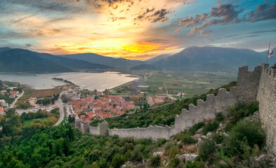 Dreamy sunset sky above Maly Ston castle and salt mines on the Adriatic Coast of Croatia