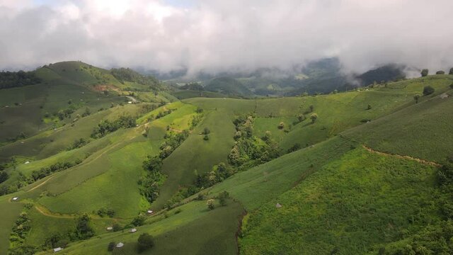 Aerial Time lapse of Morning fog at Doi Huay Hom mountain, Maelanoi, Mae Hong Son, Thailand. Beautiful farmland with soybean and corn fields on the valley.