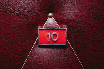 House number on a red leather door