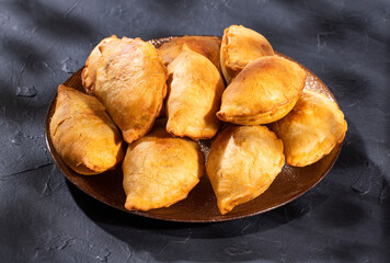 Traditional baked Argentinian empanadas savoury pastries with meat beef stuffing