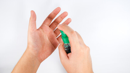 Fototapeta premium Spraying of alcohol on your hand on during COVID 19 pandemic