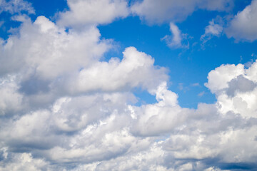 Naklejka na ściany i meble Blue sky with white clouds. Many white clouds on a sunny day. Natural background.