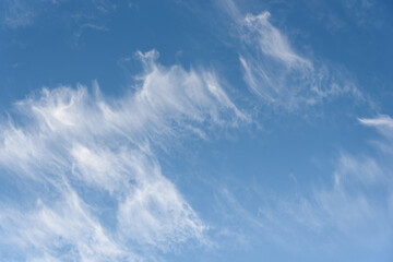 Naklejka na ściany i meble Fresh air, bright blue sky with wispy white clouds, as a nature background 