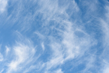Fresh air, bright blue sky with wispy white clouds, as a nature background
