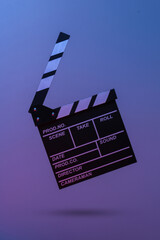 Film clapper board in blue red neon light. Cinema industry, entertainment. Minimalism, concept art....