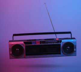 Retro radio tape recorder. in blue-red neon gradient light. Pop culture. 3D photo. 80s retro wave. Minimalism