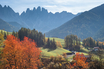 Landscape of early autumn in the village of Santa Magdalena in northern Italy on the slopes of the Dolomites in the valley of Val di Funes.