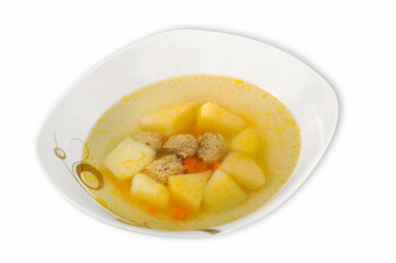 Delicious soup with meatballs and vegetables in a plate isolated on a white background.