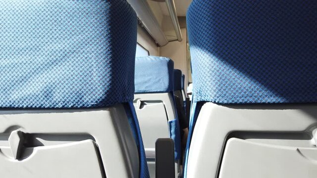 Seats with blue upholstery in the moving train