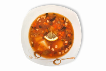 Appetizing meat soup Solyanka in the plate isolated on a white background.Top view