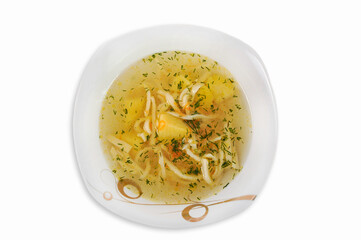 Soup with noodles and vegetables in a plate isolated on a white background.Top view