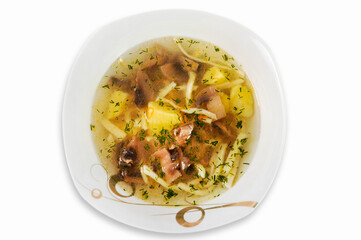Soup with noodles, mushrooms and vegetables in a plate isolated on a white background. Top view.