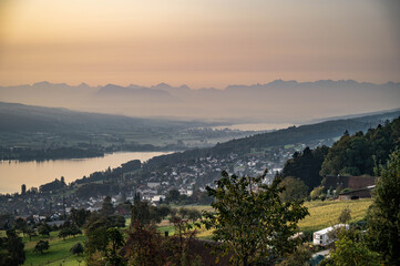 Sunrise over meadows , lakes and the alps