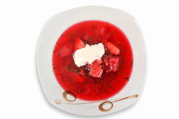 Traditional Ukrainian vegetable red soup or borsch in a plate isolated on a white background. First course. Served with sour cream. Top view.