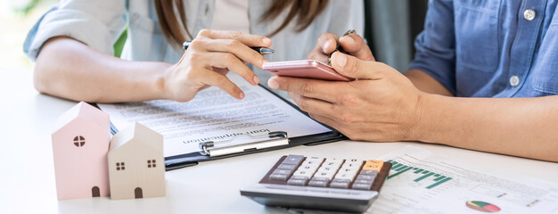 Young couple planning and looking for comparison information on their decision to buy a new home...