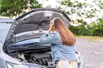 Young woman was having a bad car breakdown and felt frustrated while traveling