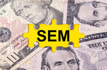 Puzzle with the image of dollars in the center of the inscription -SEM