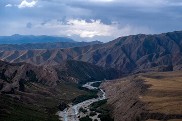 Moutain river valley with sky background. Beautiful wild nature landscape. Adventure travel. Outdoor landscape. Usek river valley in Kazakhstan. Tourism in Kazakhstan concept.