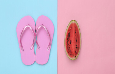 Slice of ripe watermelon and flip flops on pink blue background. Summer fun, beach rest. Top view. Flat lay