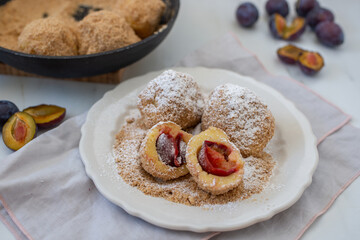Typical Austrian plum dumplings made of leavened dough and fresh plums
