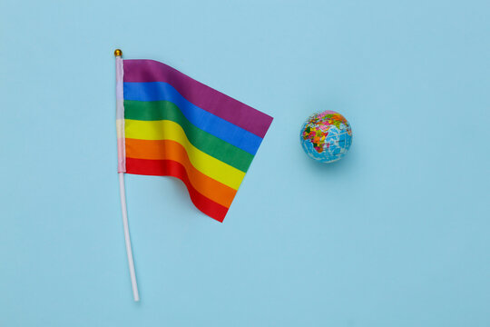 LGBT rainbow flag and globe on blue background. Tolerance, freedom