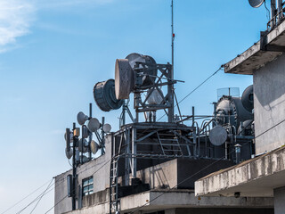 Set of communication antennas on a building rooftop