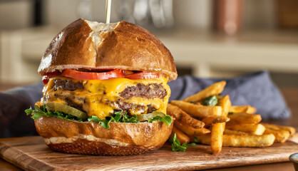 double cheeseburger with american cheese and fries on pretzel  bun - Powered by Adobe