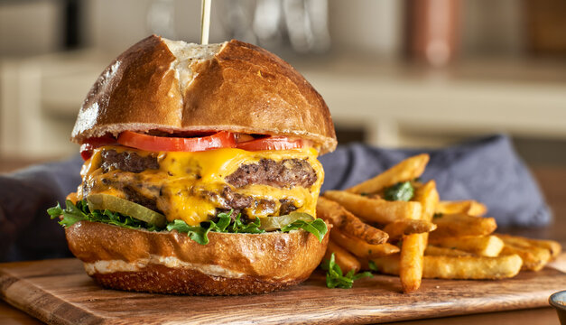 Double Cheeseburger With American Cheese And Fries On Pretzel  Bun