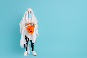 kid in ghost costume wearing face mask