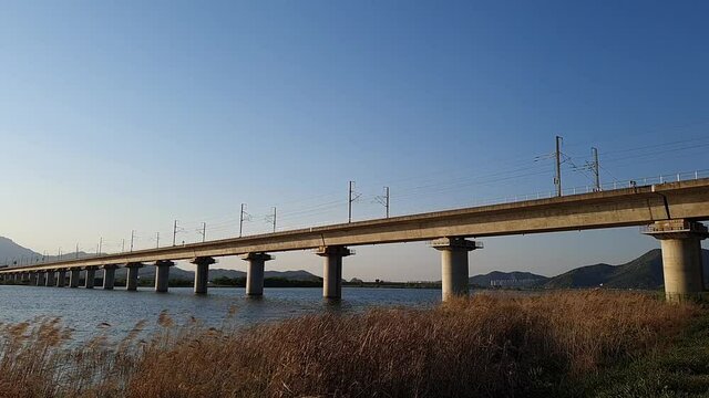 high spped train through the bridge in rural countryside, south korea