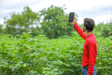 young indian man clicking selfie with mobile