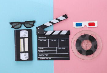 Movie clapper board and accessories on pink blue pastel background. Retro 80s. Cinema industry,...