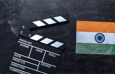 Movie clapper board and Indian flag on chalk blackboard. Cinema industry, entertainment