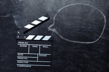 Movie clapper board with dialogue cloud on chalk blackboard. Cinema industry, entertainment - obrazy, fototapety, plakaty