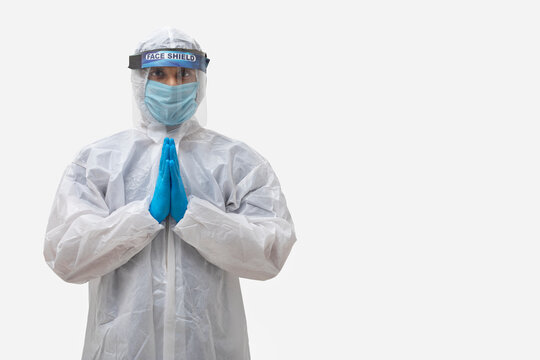 Man in a protective suit standing with his hands joined	
