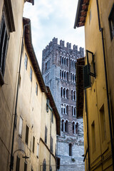 View of San Frediano Basilica Bell Tower between Buildings, Lucca, Italy