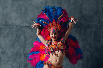 Woman in brazilian samba carnival costume with colorful feathers plumage