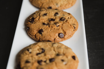 Delicious chocolate chip cookies on a white plate - homemade cookies fresh from the oven