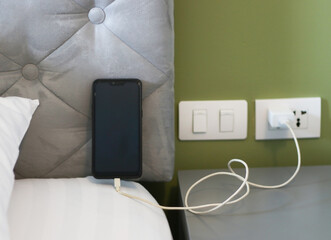 Mobile phone Charging the battery on the mattress. Possible dangers from tapping the batteries on...