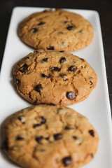 Delicious chocolate chip cookies on a white plate - homemade cookies fresh from the oven