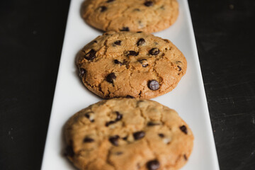 Delicious chocolate chip cookies on a white plate - homemade cookies fresh from the oven