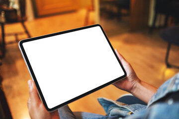 Mockup image of a woman holding digital tablet with blank white desktop screen