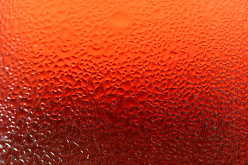 Water Droplets Texture of a Glass of Vibrant Red Chilled Drink