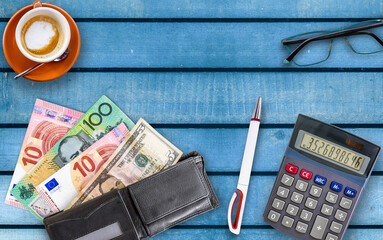 Money, Calculator. pencil, glasses and coffee on wooden table