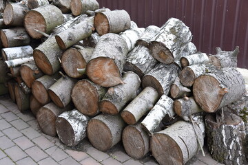 Birch logs in laying on back yard. Simple stack or storage of firewood at countryside house. Timber...