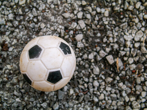 Old style traditional foot ball on a stone surface.